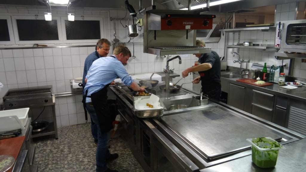 Drei Männer arbeiten in einer Küche im Hotel
